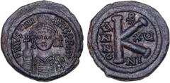 Byzantine Coins Justinian I. Æ 1/2 Follis (11.51 g), 527-565. Nicomedia, RY 15 (541/2). D N IVSTINIANVS P P AVI, helmeted and cuirassed bust of Justinian I facing, holding globus cruciger and shield. 
