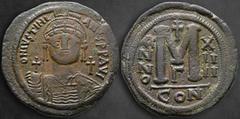 Byzantine Justinian I AD 527-565. Dated RY 14=540/1 AD. Constantinople Follis or 40 Nummi Æ 39 mm, 21,97 g DN IVSTINIANVS P P AVI, helmeted facing bust, holding globus-cruciger in right hand; cross in