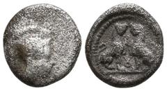 Greek Dynasts of Lycia. Uncertain Dynast circa 400 BC. Obol AR 9mm., 0,53g. Head of Athena facing to right, wearing a crested Attic helmet decorated with a volute and olive-leaves / Two confronted lio