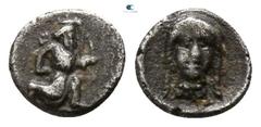 Greek Cilicia. Uncertain mint circa 400 BC. Tetartemorion AR 3mm., 0,17g. Persian king in kneeling-running stance right, holding dagger and bow, with quiver over shoulder / Female head facing slightly