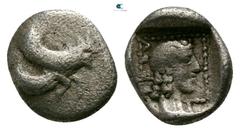 Greek Dynasts of Lycia. Uncertain mint. Uvug 470-440 BC. Hemiobol AR 6mm., 0,31g. Forepart of winged man-headed bull right / ΟFΟV, laureate head of Apollo right within dotted square border, all within