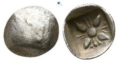 Greek Caria. Uncertain mint or Mylasa circa 400-350 BC. Achaemenid Period Tetartemorion AR 5mm., 0,12g. Head of the Persian Great King left (?) / Stellate pattern of Milesian style. very fine Cf. CNG 