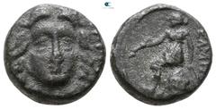 Greek Lycia. Telmessos . Before 190-189 BC, (under Antiochos III after the battle of Magnesia) Dichalkon Æ 11mm., 3,10g. Head of Helios facing / [T]EΛMH[CCEΩN?], Apollo seated left on omphalos, holdin