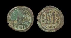 Ancient Byzantine Coins - Justinian I - Bronze Follis 527-565 AD "Constantinople mint. Obv: DN IVSTINIANVS PP AVG legend with helmeted, cuirassed bust facing, holding cross on globe and shield, cross 