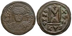 Ancient Byzantine Coins - Justinian I - Follis 527-565 AD. Cyzicus mint. Obv: DN IVSTINIANVS PP AVG legend with helmeted, cuirassed bust facing, holding cross on globe and shield, cross in right field