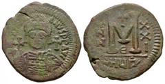 Ancient Byzantine Coins - Justinian I - Follis 527-565 AD. Antioch mint. Obv: DN IVSTINIANVS PP AVG legend with helmetted, cuirassed bust facing, holding cross on globe and shield, cross in right fiel