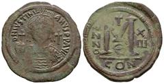 Ancient Byzantine Coins - Justinian I - Follis 527-565 AD. Constantinople mint. Obv: DN IVSTINIANVS PP AVG legend with helmetted, cuirassed bust facing, holding cross on globe and shield, cross in rig