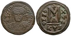 Ancient Byzantine Coins - Justinian I - Follis 527-565 AD. Cyzicus mint. Obv: DN IVSTINIANVS PP AVG legend with helmetted, cuirassed bust facing, holding cross on globe and shield, cross in right fiel