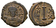 Justinian I - Decanummium. 527-565 AD. Antioch mint. Obv: DN IVSTINIANVS PP AVG legend with helmeted and cuirassed bust facing, holding cross on globe and shield, cross to right. Rev: large I with ANN