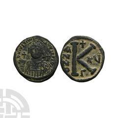 Coins - Byzantine Justinian I - AE Half Follis 527-565 A.D. Constantinople mint. Obv: D N IVSTINIANVS PP AVG legend with helmeted and cuirassed bust facing holding globus cruciger and shield; cross in