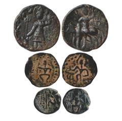 Ancient India. A group of three Copper Kushan coins of late period (250-300 AD), (a) Obv: King standing holding trident and offering sacrifice at an altar with trident. Rev: Shiva reclining against Na