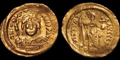 Byzantine BYZANTINE EMPIRE. Justin II. 565-578. AV solidus. 4.35 gm. 21 mm. Constantinople mint, 1st officina. His helmeted and cuirassed bust facing, holding Victory on globe and shield decorated wit