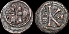 Byzantine BYZANTINE EMPIRE. Justin II, with Sophia. 565-578. Æ half follis. 4.11 gm. 20 mm. Semi-barbarous imitation. Justin and Sophia seated facing on double throne, globus cruciger to either side /