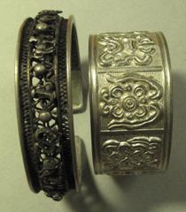 COINS. CHINA – ANCIENT. Miscellaneous Silver Bangles (2), open-work design featuring the twelve lunar animals, outside diameter 72mm, weight 48g; and eight auspicious symbols, outside diameter 62mm, w