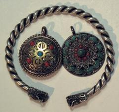 COINS. CHINA – ANCIENT. Miscellaneous Silver Bangle, rope-like design with dragon head at each end, outside diameter 70mm; Silver Pendant (2), decorated with coral and turquoise, both 30mm in diameter