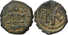 ANCIENT COINS Byzantine Empire, Justinian I, Half follisByzantine EmpireJustinian I (527-565), Half follis, Antioch mint Obverse: Justin seated on throne, holding globe, Sophia on right D N IVSTINIANV