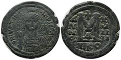 Byzantine Coins Justinian I. AD 527-565. AE Follis (35mm, 20.14g). Nicomedia. D N IVSTINIANVS P P AVC. Helmeted, draped and cuirassed bust facing, holding globus cruciger and shield; cross in right fi