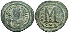BYZANTINE COINS JUSTINIAN I.(527-565).Constantinople.Follis. Obv : D N IVSTINIANVS P P AVC. Helmeted, cuirassed bust facing, holding cross on globe and shield with horseman motif, cross to right. Rev 