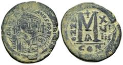 Byzantine Coins JUSTINIAN I.(527-565).Constantinople.Follis. Obv : D N IVSTINIANVS P P AVC. Helmeted, cuirassed bust facing, holding cross on globe and shield with horseman motif, cross to right. Rev 
