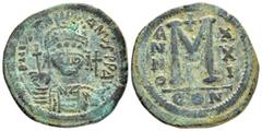 Byzantine Coins JUSTINIAN I.(527-565).Constantinople.Follis. Obv : D N IVSTINIANVS P P AVC. Helmeted, cuirassed bust facing, holding cross on globe and shield with horseman motif, cross to right. Rev 