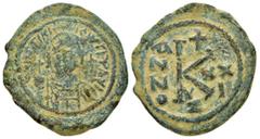 Byzantine Coins JUSTINIAN I.(527-565).Constantinople.Half Follis. Obv : D N IVSTINIANVS P P AVG. Diademed, helmeted, and cuirassed facing bust, holding globus cruciger and shield; cross to right. Rev 
