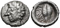 Greek WESTERN ASIA MINOR, Uncertain. 5th century BC. AR Tetartemorion(?) (6mm, 0.16 g, 1h). Male head left / Barley grain; letters(?) to right; all within incuse circle. Cf. CNG E-378, lot 210; otherw