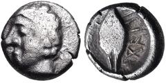 Greek WESTERN ASIA MINOR, Uncertain. 5th century BC. AR Tetartemorion(?) (5.5mm, 0.24 g, 3h). Male head left / Barley grain; letters(?) to right; all within incuse circle. Cf. CNG E-399, lot 182 and C