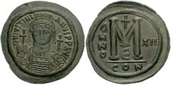Justinian I. 527-565. Æ Follis (44mm, 22.45 g, 6h). Constantinople mint. Dated RY 12 (538/9 AD). Helmeted facing bust, holding globus cruciger and shield; cross to right / Large M; cross above, date a
