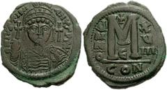 Justinian I. 527-565. Æ Follis (34mm, 19.74 g). Constantinople mint. Dated RY 18 (544/5). Helmeted facing bust, holding globus cruciger and shield; cross to right / Large M; cross above, date across f