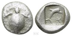 Greek Coins ATTICA. Aegina. Obol (Circa 480 BC). Obv: Sea turtle. Rev: Dolphin swimming right; floral ornament to lower right; all within incuse square. Traité 1046; BMC 145; Milbank pl. I, 10. Extrem