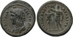 LYDIA. Tripolis. Trajan (98-117). Ae. Obv: ΙЄΡΑ СVΝΚΛΗΤΟС ΤΡΙΠΟΛ. Bareheaded and draped bust of the Senate left. Rev: ΑV ΚΑΙ ΤΡΑΙΑΝΟС ΔΑΚΙΚΟС. Trajan standing left, holding spear and crowning trophy t