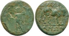LYDIA. Tralles. Ae (2nd-1st centuries BC). Obv: Zeus standing facing, holding crowning Nike and sceptre; all within wreath. Rev: ΤΡΑΛΛΙ / ΑΝΩΝ. Bull standing right; c/m: Male head right within incuse 