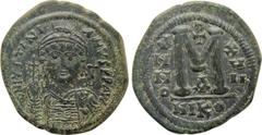 Byzantine Coins JUSTINIAN I (527-565). Follis. Nicomedia. Dated RY 17 (543/4). Obv: D N IVSTINIANVS P P AVG. Helmeted and cuirassed bust facing, holding globus cruciger and shield decorated with horse