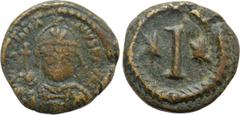 Byzantine Coins JUSTINIAN I (527-565). Decanummium. Rome. Obv: D N IVSTINIANVS P AVG. Helmeted and cuirassed bust facing, holding globus cruciger and shield decorated with horseman motif. Rev: Large I