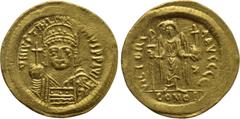 Byzantine Coins JUSTINIAN I (527-565). GOLD Solidus. Constantinople. Obv: D N IVSTINIANVS P P AVG. Helmeted and cuirassed bust facing, holding globus cruciger and shield with horseman motif. Rev: VICT