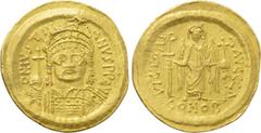 Byzantine Coins JUSTINIAN I (527-565). GOLD Solidus. Constantinople. Obv: D N IVSTINIANVS P P AVG. Helmeted and cuirassed bust facing, holding globus cruciger and shield decorated with horseman motif.