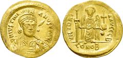 Byzantine Coins JUSTINIAN I (527-565). GOLD Solidus. Constantinople. Obv: D N IVSTINIANVS P P AVG. Helmeted and cuirassed bust facing slightly right, holding spear and shield decorated with horseman m