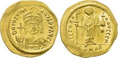 Byzantine Coins JUSTINIAN I (527-565). GOLD Solidus. Constantinople. Obv: D N IVSTINIANVS P P AVG. Helmeted and cuirassed bust facing, holding globus cruciger and shield decorated with horseman motif.