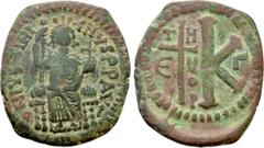 Byzantine Coins JUSTINIAN I (527-565). Half Follis. Theoupolis (Antioch). Obv: DN IVSTINIANVS PP AV. Justinian enthroned facing, holding scepter and globus cruciger. Rev: THEUP / Γ. Large K; to left c