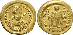 Byzantine Coins JUSTINIAN I (527-565). GOLD Solidus. Constantinople. Obv: D N IVSTINIANVS P P AVG. Helmeted and cuirassed bust facing slightly right, holding spear and shield decorated with horseman m