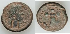 JUDAEA CAPTA. Local issues. Titus (AD 79-81). Æ 23mm (12.84 gm). Caesarea Maritima, AD 79-81. Laureate head of Titus right; countermark: head to right / Trophy; to left, Judaea seated left, with hands