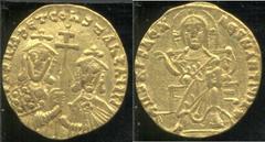 Byzantine Basil I 867-886 AD gold solidus, Christ enthroned, facing, wearing nimbus crown, pallium, and colobium, and raising right hand in benediction/Facing busts of Basil, with short beard, and Con