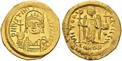 BYZANTINE COINS BYZANTINE EMPIRE. JUSTINIANUS I, 527-565. Solidus, Constantinople. AV. 4,44 g. D N IVSTINVS P P AVG Helmeted and cuirassed bust facing slightly right, holding spear and shield with hor
