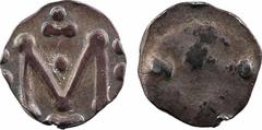 Merovingian times Aquitaine, Melle, denier, c.700 M dans le champ entre deux tildes pointées, et entre deux fois deux besants Champ quasiment lisse avec deux globules Argent 11,2 mm 1,25 g 10 h TTB+ /