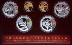 China. Gold and Silver Set for the Beijing Olympic Games, 2008. Gold 150 Yuan (2 pieces). 1/3 Ounce each .999 fine gold. Silver 10 Yuan (4 pieces) 1 ounce each. Gold features an ancient Chinese Cuju e