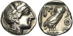 Greek world ATTIQUE, ATHENES, AR tétradrachme, vers 449-404 av. J.-C. D/ T. casquée d'Athéna à d., le casque l. et orné d'un fleuron. R/ AΘE Chouette à d., t. de f. A g., pousse d'olivier avec fruit e