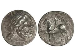 Tetradracma. Siglo III a.C. FILIPO II. IMITACIÓN CELTAS DEL DANUBIO. Anv.: Cabeza laureada de Zeus a derecha. Rev.: Jinete a izquierda, alrededor leyenda y símbolos. 14,20 grs. AR. Se-203 var. MBC+.