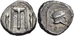 Greek BRUTTIUM. Temesa. Circa 475-425 BC. Nomos (Silver, 19.5 mm, 8.18 g, 9 h). Between two greaves, tripod with three ring handles, and legs ending in lion's paws. Rev. ΤΕΜ Corinthian helmet with cre