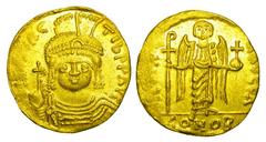 BYZANTINE EMPIRE. Maurice Tiberius, 582-602 AD. Gold Solidus (4.16 gm) of Antioch. Helmeted facing bust / Angel standing with long Christogram and globus cruciger. S.524. Near Mint, some die rust.