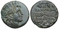 Kingdom of Macedon. Philip V Æ23. Circa 221-179 BC. Radiate head of Helios right / BASILEWS FILIPPOU above and below winged thunderbolt; monogram DI above; all within oak wreath. A. Mamroth, Die Bronz